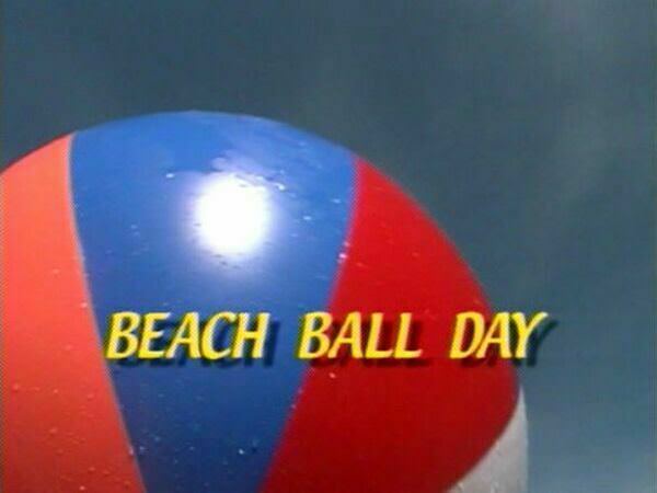 Nudists on a beach play a huge ball