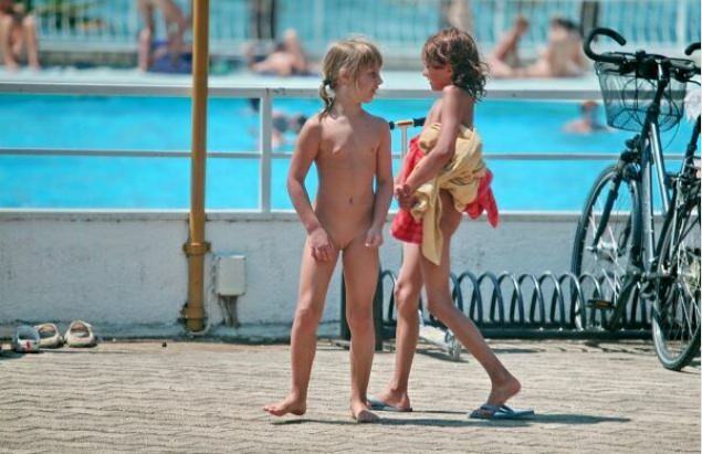 Young and adult nudists in an aquapark