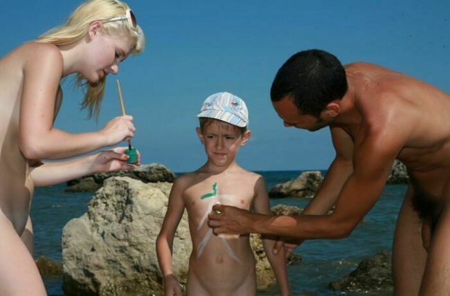 Family summer holiday of nudists on the seashore - Purenudism family